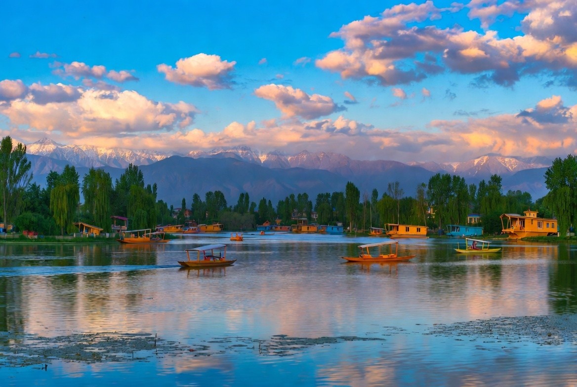 Dal Lake Srinagar with colorful shikaras, houseboats and floating gardens against Zabarwan mountains