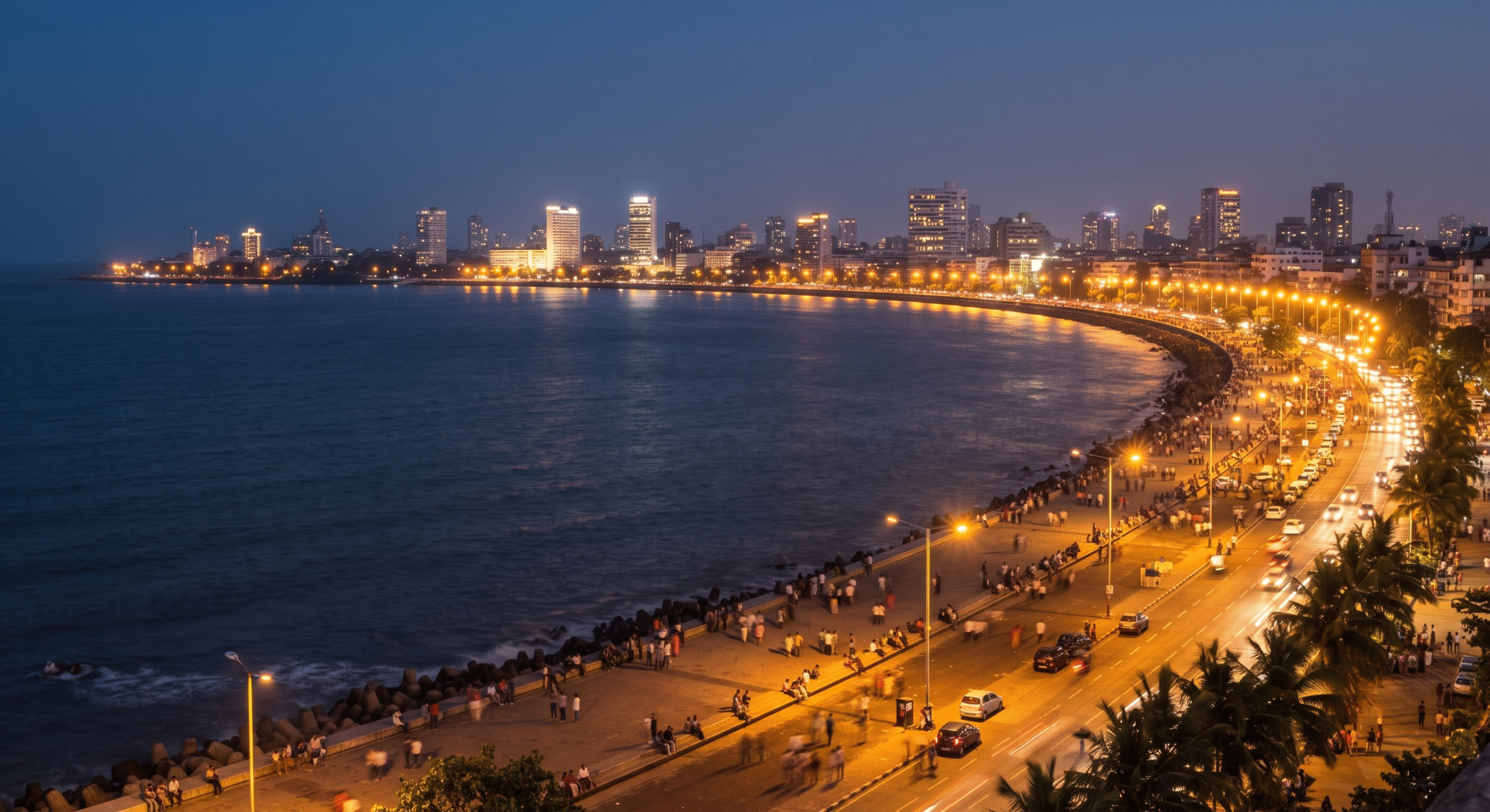 The glittering C-shaped curve of Marine Drive Mumbai lit up at night along the Arabian Sea coast, known as the Queen's Necklace.